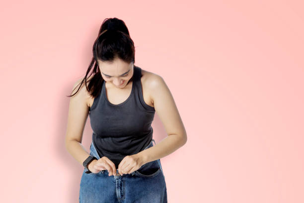 istock Happy woman wearing her old pants in the studio 1481560647