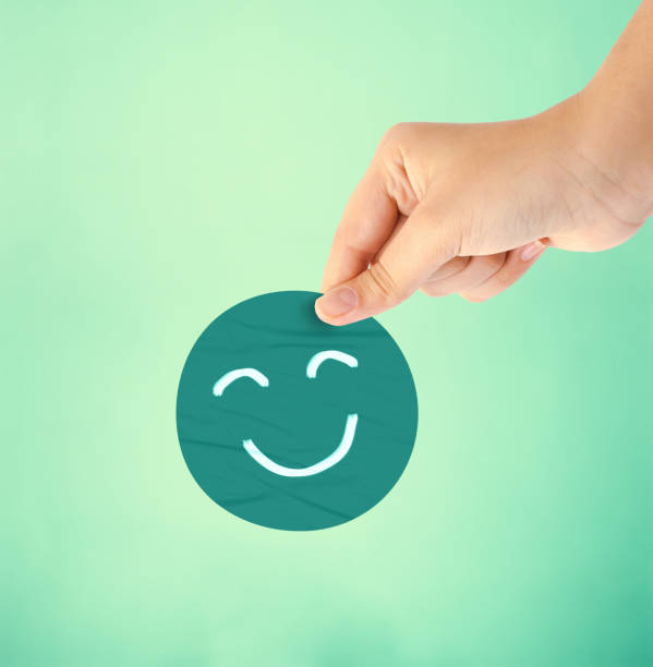 istock Hand holding blue happy smile face paper cut 1481565163
