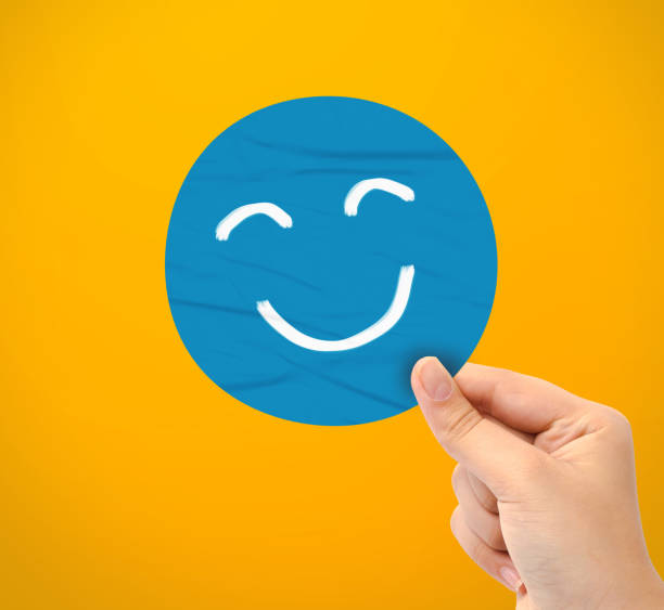 istock Hand holding blue happy smile face paper cut 1481565264