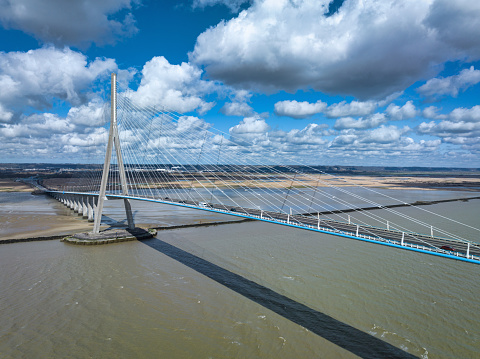 Le Havre, France - March 19, 2023: Pont de Normandie - Normandy Bridge cable-stayed road bridge spans the river Seine linking the City of Le Havre to Honfleur City in Normandy, Northern France. The total length is 2.1km - 7,032 ft, It's the last bridge to cross the Seine before it empties into the ocean in Normandy. Pond de Normanie, Le Havre, Northern France, Europe.