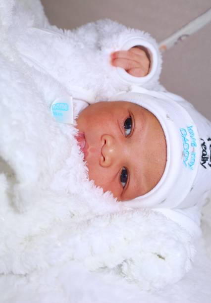 Newborn  baby in deep sleep covered in blankets