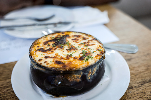 Moussaka is a very typical Greek dish. \nIt is an eggplant- or potato-based dish and very similar to Shepherd's pie.\nWhat we had at a Greek restaurant was eggplant-based.