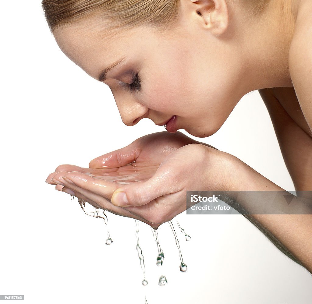 cute young woman wash her face with water Close-up portrait of a cute young woman wash her face with water Adult Stock Photo
