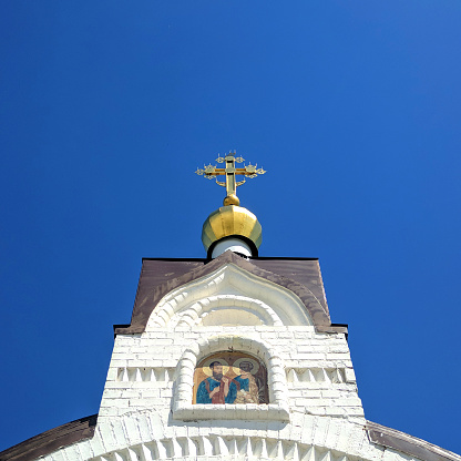 Golden cross on a Christian temple with an icon, Russia, city of Belgorod village of Prokhorovka May 23, 2021