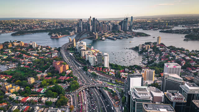 4K Aerial view Hyper lapse Footage of above Crowded Traffic and transportation on expressway though Sydney Harbour Bridge, Lavender bay and Circular Quay