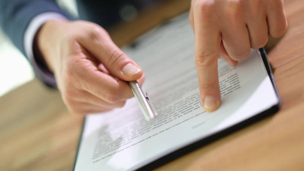 istock Manager giving ballpoint pen to client to signing contract document in office closeup 1481581477