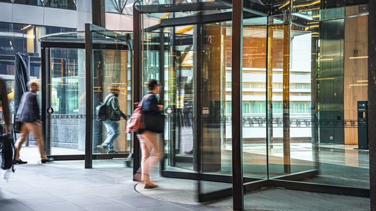 4K Footage Time lapse of Crowded Commuter business people entering and leaving office building via automatic Revolving Door in Melbourne