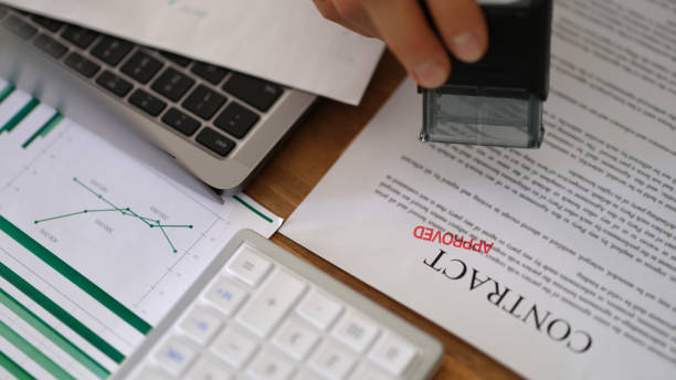 istock Manager hand putting stamp approved on contract document form in office closeup 1481581562