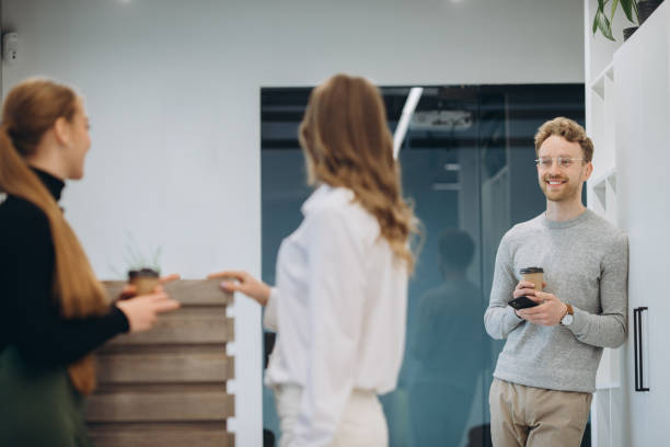 istock Business people talking while holding coffee cups at office cafeteria 1481582651