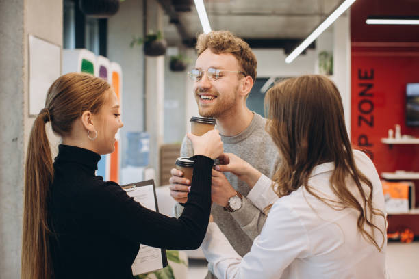 istock Businessman serving coffee to colleagues in office 1481582686