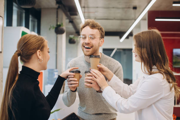istock Businessman serving coffee to colleagues in office 1481582695