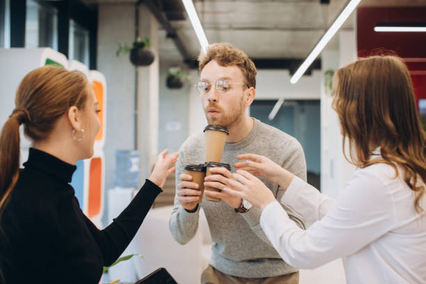 istock Businessman serving coffee to colleagues in office 1481582696