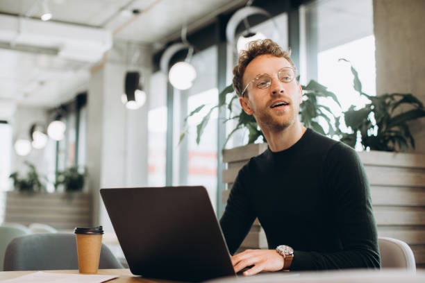 istock Man using laptop sitting at conference table in office 1481584262