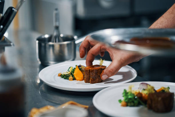 istock chef dishing up steak in professional kitchen 1481586069