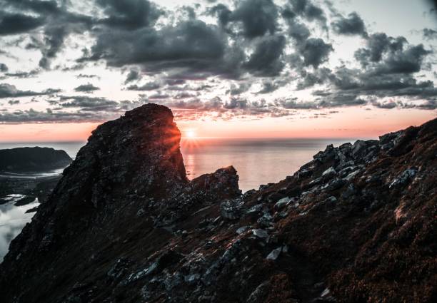 istock a sunrise view on the rocks and water under clouds, as the sun sets 1481586093