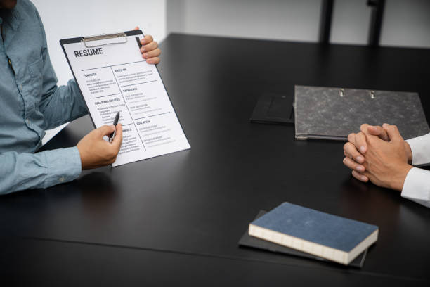 istock Examiner reading a resume during job interview at office Business and human resources concept. 1481587133
