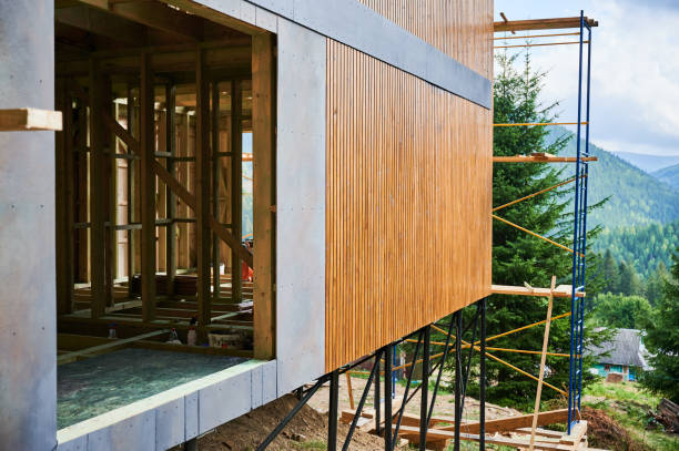 istock Wooden frame house under construction near forest. 1481587384