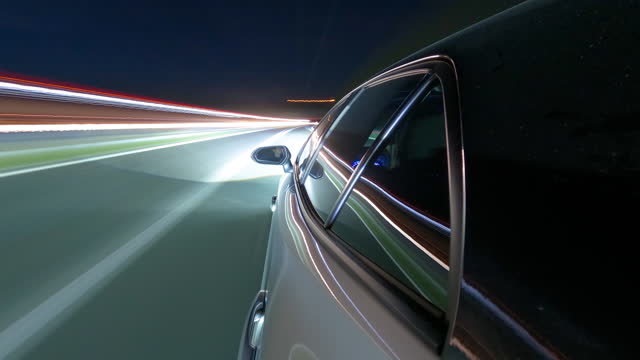 Nighttime highway drive with blurred lights, captured in a time-lapse