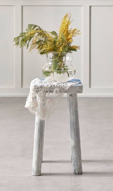istock White brick wall and flower on wooden stool. 1481587917