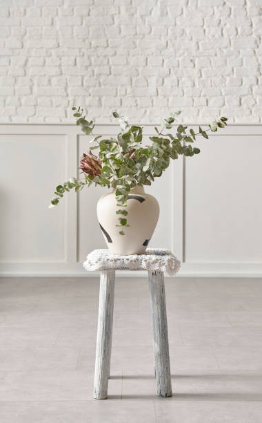 istock White brick wall and flower on wooden stool. 1481587991