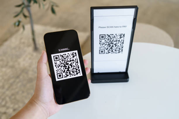 istock Qr code payment. E wallet. Man scanning tag accepted generate digital pay without money.scanning QR code online shopping cashless payment and verification technology concept. 1481588116