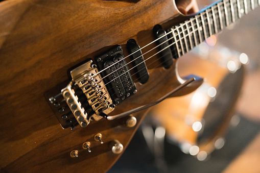 Close up of a wooden electric guitar at the recording studio