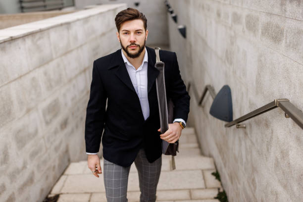 istock Young businessman moving upstairs while going to work 1481594274