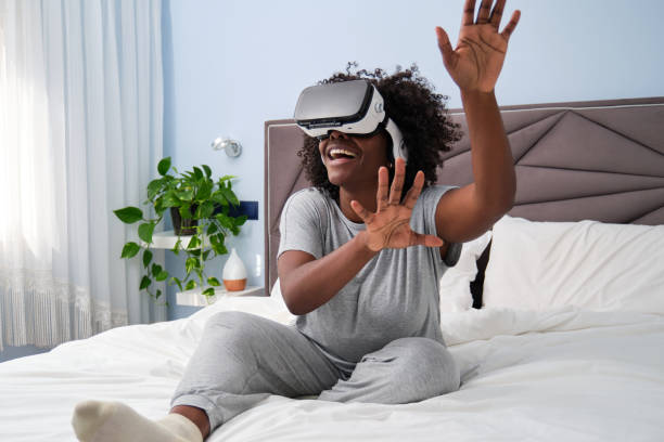 istock Immersive virtual reality experience for young African woman from her bed. 1481594709