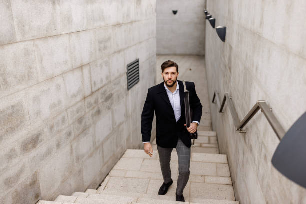 istock Young businessman moving upstairs while going to work 1481595014