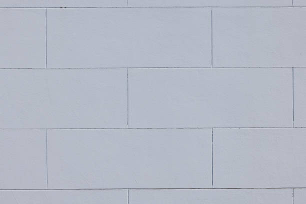 Part of a blank painted concrete wall.