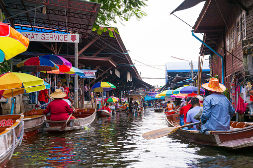 Damnoen Saduak, Thailand - 6 October 2019: Floating market with fruits, vegetables and different items sold from small boats, in Damnoen Saduak, Thailand