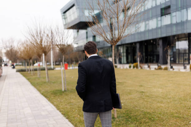 istock Rear view of young businessman going to work 1481595854