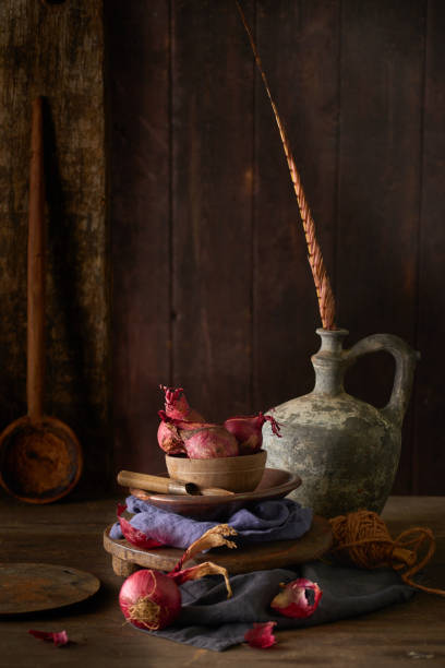 istock Still life with a vase and onions and cloths 1481596384