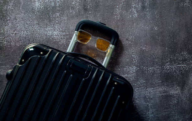 istock Black travel bag,Black luggage set on dark background, top view image, flat lay composition. Travel minimalist concept, black and dark classic baggage mockup, small and big. Suitcase accessory set, journey 1481597736