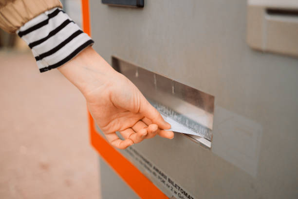 istock Woman buying a ticket to the subway train using an electronic terminal, takes a printed check from an ATM 1481599041
