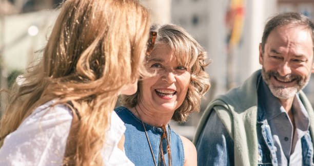 Smiling mature friends walking on street