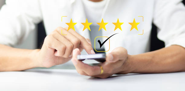 istock Customer pressing  five star icon on smartphone for feedback review satisfaction service 1481599527