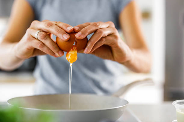 istock Close up of cracking an egg. 1481599591