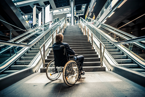 Businessman on a wheelchair against modern stairs. iStockalypse 2012 in Berlin.