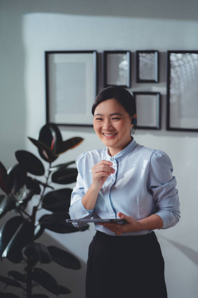 istock Asian woman enjoy with working online, reading data on tablet and using laptop talking on video conference at home office. 1481606708