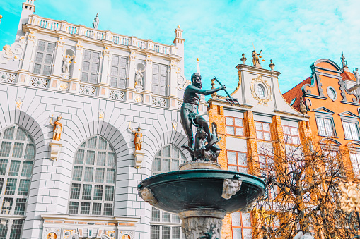 Neptune's Fountain, a famous historical landmark and colorful gothic houses in Gdansk, Poland, Europe. High quality photo