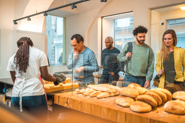 istock Black Female Offering Freshly Baked Bread At An Artisan Bakery 1481608548