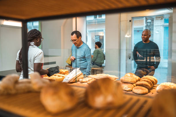 istock Black Female Offering Freshly Baked Bread At An Artisan Bakery 1481608560