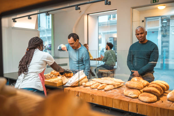 istock Black Female Offering Freshly Baked Bread At An Artisan Bakery 1481608565