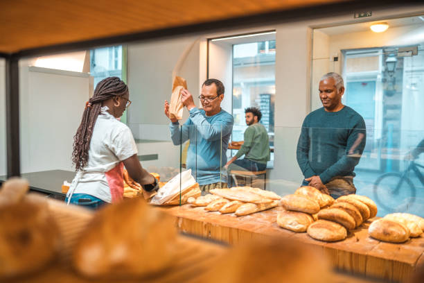istock Black Female Offering Freshly Baked Bread At An Artisan Bakery 1481608567