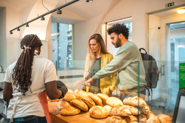 istock Black Female Offering Freshly Baked Bread At An Artisan Bakery 1481608572
