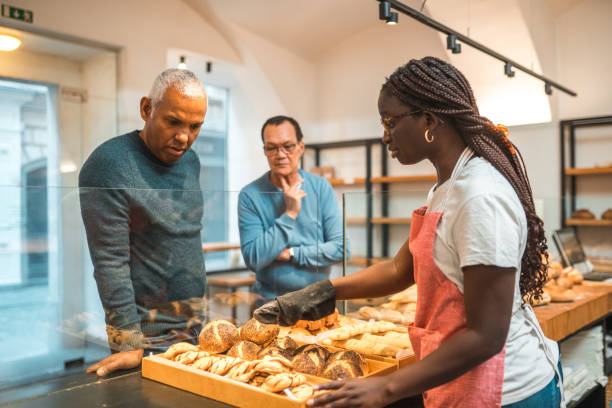 istock Black Female Offering Freshly Baked Bread At An Artisan Bakery 1481608601