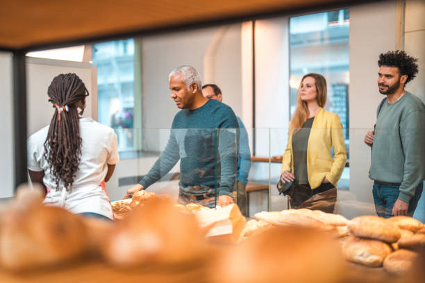 istock Black Female Offering Freshly Baked Bread At An Artisan Bakery 1481608612