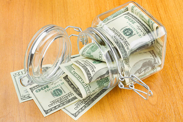 istock dollars in glass jar 148161031