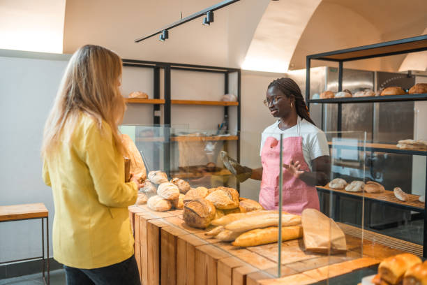 istock Black Female Offering Freshly Baked Bread At An Artisan Bakery 1481610981